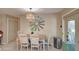 Dining area featuring a rustic wooden table, custom light fixture, and ample natural light at 1828 West Pkwy, Deland, FL 32724