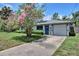 Inviting home featuring a blue front door and a well-maintained driveway at 1828 West Pkwy, Deland, FL 32724