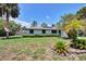 Well-kept single-story home with a manicured lawn and beautiful landscaping at 1828 West Pkwy, Deland, FL 32724