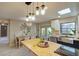 Open kitchen and dining area featuring butcher block island, stainless sink, and modern lighting fixtures at 1828 West Pkwy, Deland, FL 32724