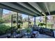 Relaxing screened patio with comfortable seating and lush greenery, perfect for outdoor living at 1828 West Pkwy, Deland, FL 32724