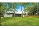 Expansive backyard offering lush greenery, privacy fencing, and mature trees, creating a serene outdoor space at 1917 Alameda Dr, Deltona, FL 32738