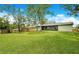 Large, grassy backyard with a wooden fence, providing a private and spacious area for outdoor activities at 1917 Alameda Dr, Deltona, FL 32738