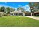 Charming single-story home featuring a well-manicured lawn, attached two car garage, and inviting curb appeal at 1917 Alameda Dr, Deltona, FL 32738