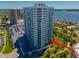 High-rise condo building with a parking area, golf course, and scenic water views at 2 Oceans West Blvd # 305, Daytona Beach, FL 32118