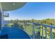 Enjoy green views from this condo balcony, featuring blue flooring and white railing at 2 Oceans West Blvd # 305, Daytona Beach, FL 32118
