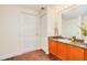Bathroom featuring wooden cabinets and a large mirror at 2 Oceans West Blvd # 305, Daytona Beach, FL 32118