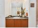 Bathroom features a vanity with granite countertop and a decorative mirror and lighting at 2 Oceans West Blvd # 305, Daytona Beach, FL 32118