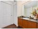 Bathroom with granite counters, vanity with wooden cabinets, and neutral wall and tile colors at 2 Oceans West Blvd # 305, Daytona Beach, FL 32118