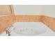 Clean, white soaking tub with jets and ceramic tile surround, offering relaxation at 2 Oceans West Blvd # 305, Daytona Beach, FL 32118