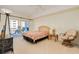 Bright bedroom with sliding glass doors to a balcony and neutral decor at 2 Oceans West Blvd # 305, Daytona Beach, FL 32118