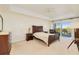 Well-lit main bedroom suite featuring a ceiling fan and balcony access at 2 Oceans West Blvd # 305, Daytona Beach, FL 32118