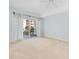 Spacious bedroom with neutral carpet, ceiling fan, and balcony access at 2 Oceans West Blvd # 305, Daytona Beach, FL 32118