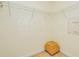 Empty walk-in closet with wire shelving and a small wicker basket on the carpet floor at 2 Oceans West Blvd # 305, Daytona Beach, FL 32118