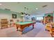 Spacious game room featuring a pool table, comfortable seating, and a well-stocked bookshelf at 2 Oceans West Blvd # 305, Daytona Beach, FL 32118