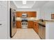 Fully equipped kitchen with stainless steel appliances, granite counters, and tiled floor at 2 Oceans West Blvd # 305, Daytona Beach, FL 32118