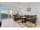 Inviting living room with balcony access, comfortable sofas, and stylish area rug at 2 Oceans West Blvd # 305, Daytona Beach, FL 32118