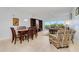 Bright open-concept living and dining area with balcony access and comfortable seating at 2 Oceans West Blvd # 305, Daytona Beach, FL 32118