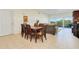 Bright condo living room features dining area, sliding glass doors, and comfortable seating at 2 Oceans West Blvd # 305, Daytona Beach, FL 32118
