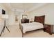 Bright main bedroom featuring a ceiling fan, wood furniture set, and carpet flooring at 2 Oceans West Blvd # 305, Daytona Beach, FL 32118