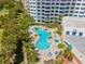 Aerial view of the community pool featuring lounge chairs and lush landscaping at 2 Oceans West Blvd # 305, Daytona Beach, FL 32118