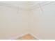 Empty walk-in closet with wire shelving and neutral carpeting at 2 Oceans West Blvd # 305, Daytona Beach, FL 32118