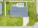 Overhead view of a property showcasing a well-maintained roof, green lawn, a shed, and a concrete driveway at 203 Fox Pl, Port Orange, FL 32127