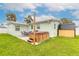 Landscaped backyard featuring a hot tub, outdoor seating, and a shed at 203 Fox Pl, Port Orange, FL 32127