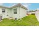 View of home's backyard featuring green grass and exterior utilities at 203 Fox Pl, Port Orange, FL 32127