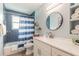 Well-lit bathroom featuring blue tiling and a decorative mirror at 203 Fox Pl, Port Orange, FL 32127