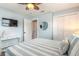 Bright bedroom featuring a mounted TV, vanity table, and coastal decor elements at 203 Fox Pl, Port Orange, FL 32127