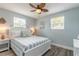 Bright bedroom featuring a white bed frame, blue striped bedding, and stylish coastal decor at 203 Fox Pl, Port Orange, FL 32127