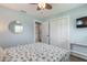 Bedroom featuring a wardrobe, mirror, TV, and ensuite bathroom entrance at 203 Fox Pl, Port Orange, FL 32127