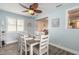 Charming dining area with a ceiling fan and view into the kitchen at 203 Fox Pl, Port Orange, FL 32127