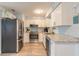 Modern kitchen with white cabinetry, stainless steel appliances, and granite countertops at 203 Fox Pl, Port Orange, FL 32127