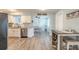 Bright kitchen flows into the dining area, featuring white cabinets and stainless steel appliances at 203 Fox Pl, Port Orange, FL 32127