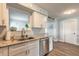 Well-lit kitchen with stainless steel dishwasher and a view to another room at 203 Fox Pl, Port Orange, FL 32127