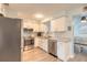 Bright kitchen featuring stainless steel appliances, light countertops, and white cabinetry at 203 Fox Pl, Port Orange, FL 32127