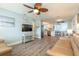 Open-concept living room flows into the kitchen and dining area, featuring stylish wood-look floors at 203 Fox Pl, Port Orange, FL 32127