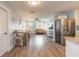 Open floor plan from living area to kitchen, featuring stainless appliances and wood-look flooring at 203 Fox Pl, Port Orange, FL 32127