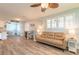 Bright living room with wood-look flooring and an open floor plan that flows into kitchen at 203 Fox Pl, Port Orange, FL 32127