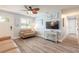 Cozy living room with neutral decor, featuring wood-look flooring and plantation shutters at 203 Fox Pl, Port Orange, FL 32127