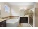 Bathroom with walk-in shower, soaking tub, and double vanities at 218 Wellington Woods Ave, Deland, FL 32724