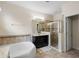 Bright bathroom features a soaking tub, glass shower, and granite vanity at 218 Wellington Woods Ave, Deland, FL 32724