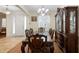 Formal dining room showcasing classic wood furniture, elegant lighting, and a view of the front door at 218 Wellington Woods Ave, Deland, FL 32724