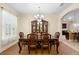 Bright dining room with hardwood floors, stylish lighting, and seamless flow into adjacent rooms at 218 Wellington Woods Ave, Deland, FL 32724