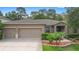 Charming single-story home with a well-maintained lawn, complemented by a neatly landscaped garden and a two-car garage at 218 Wellington Woods Ave, Deland, FL 32724
