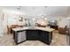 Kitchen island with dining area, stainless steel appliances, and modern lighting at 218 Wellington Woods Ave, Deland, FL 32724
