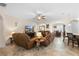Open living room with tile floors, leather furniture, and decorative touches at 218 Wellington Woods Ave, Deland, FL 32724