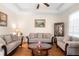 Inviting living room with tray ceiling, plush seating, and a decorative glass-topped coffee table at 218 Wellington Woods Ave, Deland, FL 32724